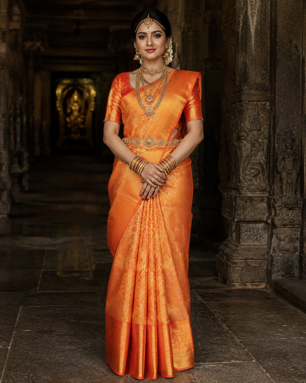Sunset orange Kanjivaram silk saree with gold zari border, draped on model — Sunset Orange Kanjivaram Silk Saree, Vasthara Boutique