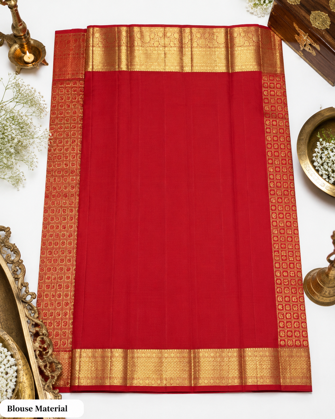 Red saree with gold border on a white background