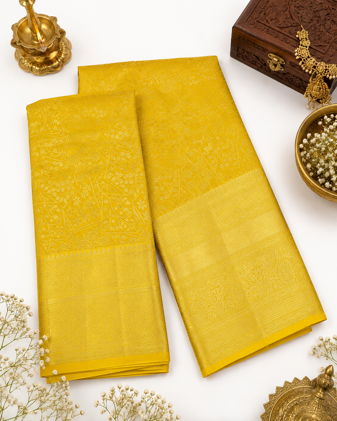 Yellow saree with decorative elements on a white background