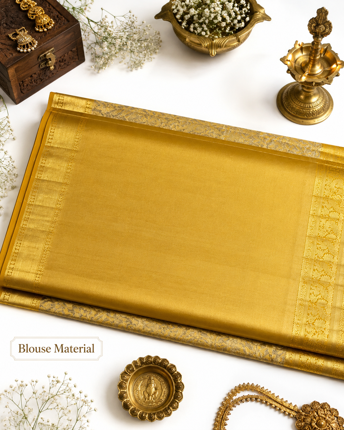 Gold saree with intricate patterns on a white background