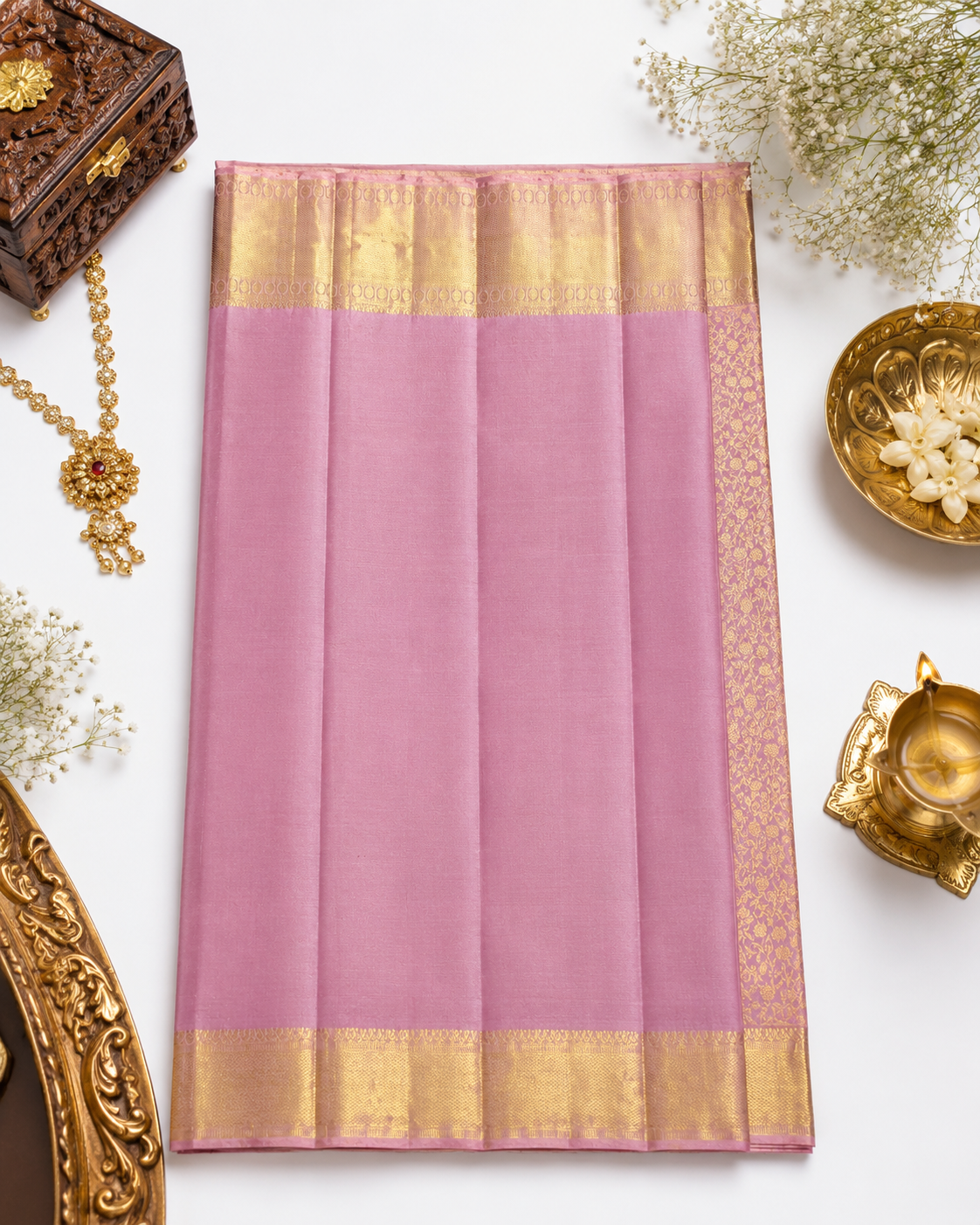 Pink saree with gold border on a white background