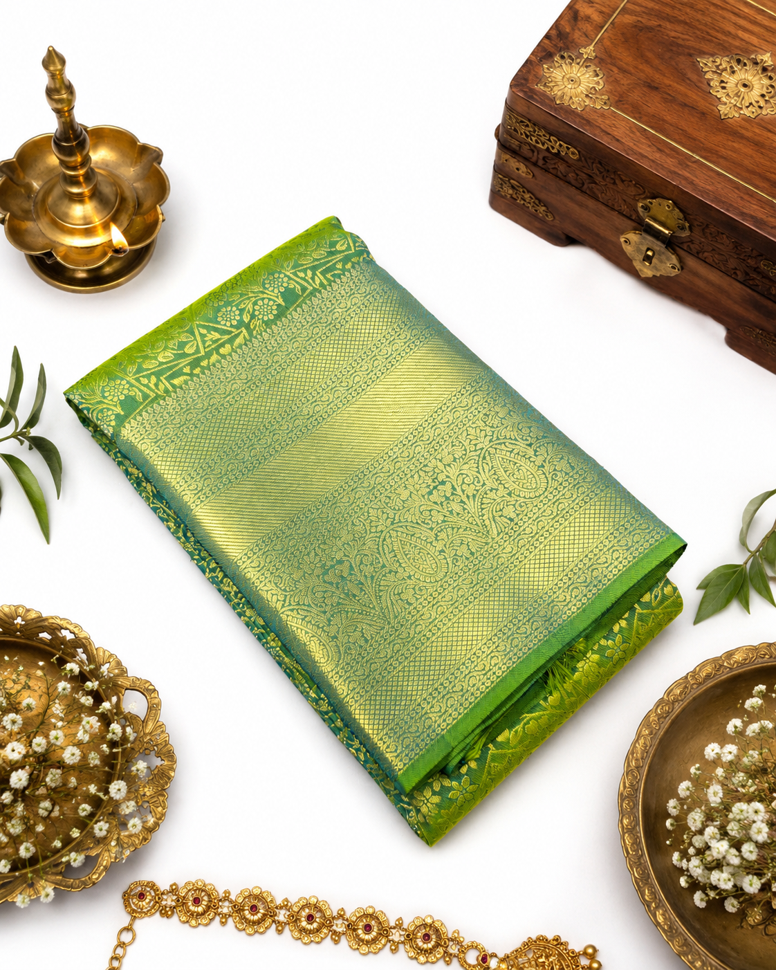 Green saree with gold patterns on a white background
