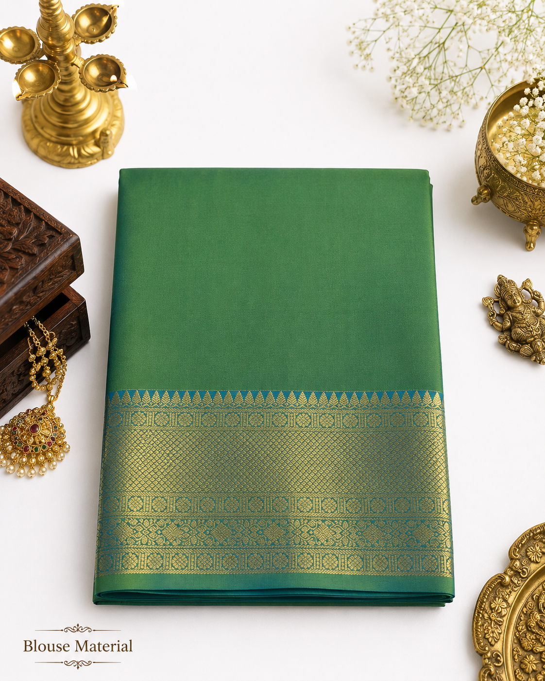 Green saree with gold border on a white background