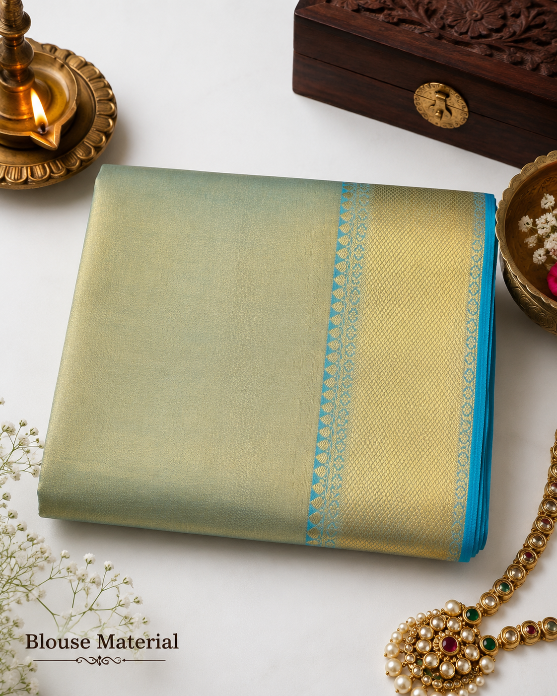 Folded saree with decorative elements on a white background