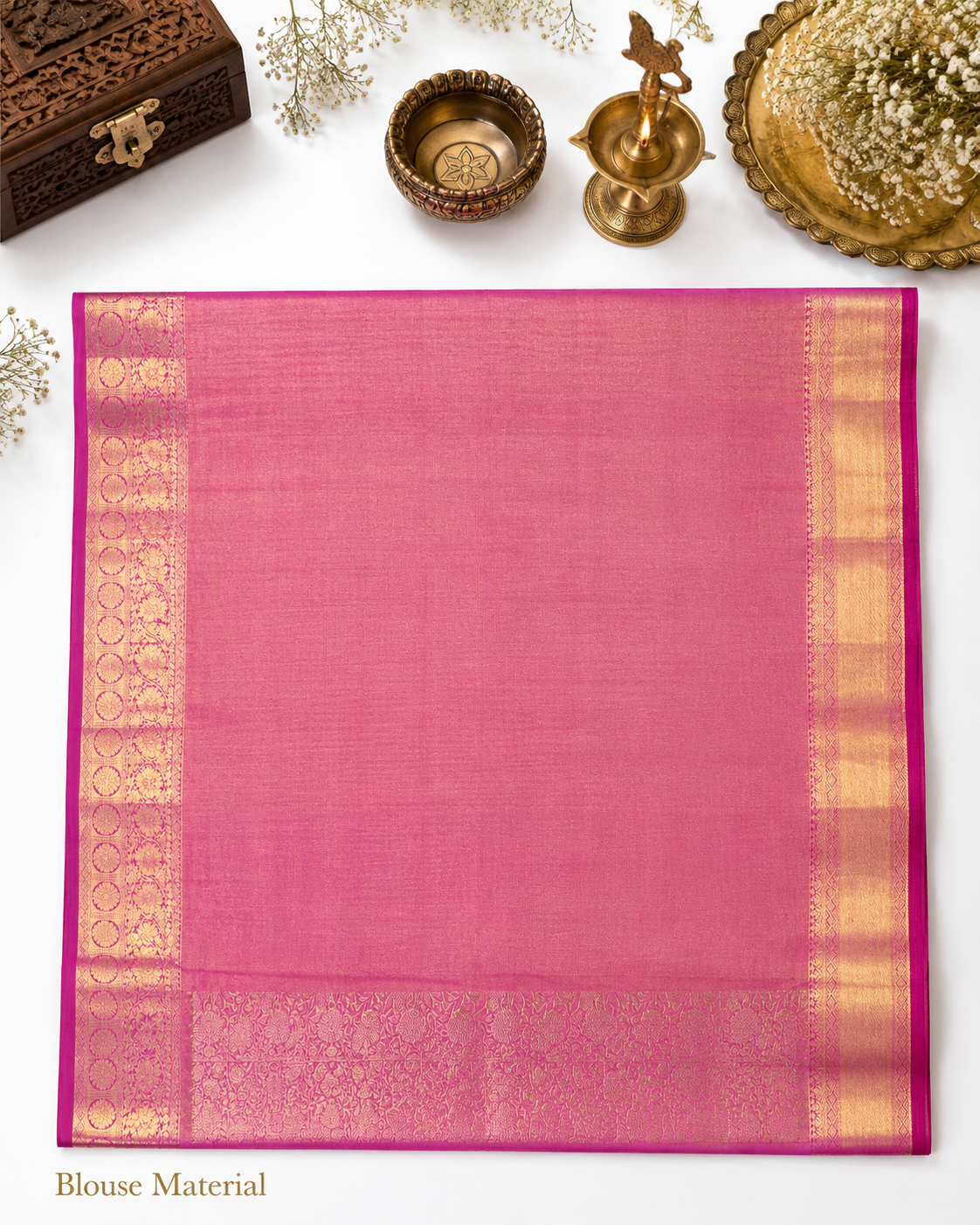 Pink blouse material with gold border on a white background