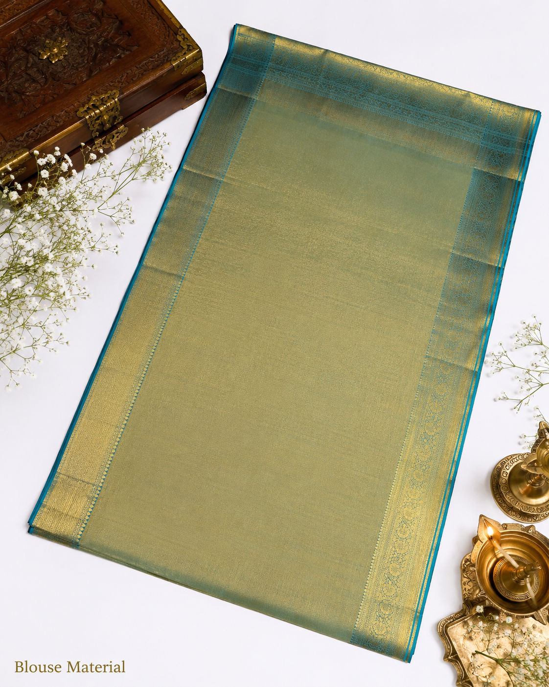 Green saree with gold border on a white background
