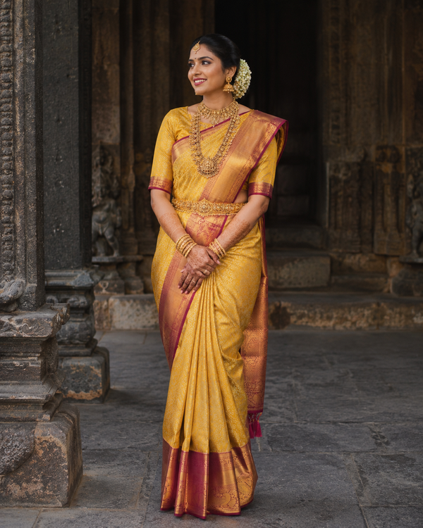 Turmeric yellow Kanjivaram silk saree with maroon border and gold zari, draped on model — Turmeric Yellow Kanjivaram Silk Saree, Vasthara Boutique